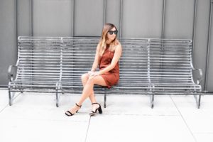 elizabeth and james brown suede dress with celine luca sunglasses sitting on bench