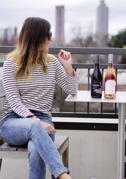 blogger with rainstorm wine pinot noir and rose on rooftop