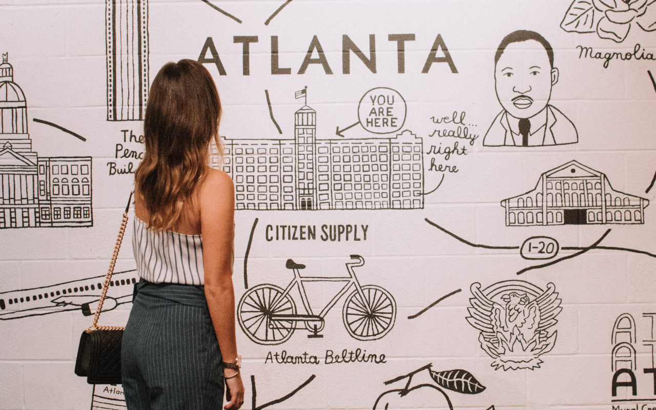 style blogger in front of atlanta map