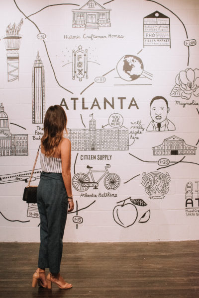 style blogger in front of atlanta map