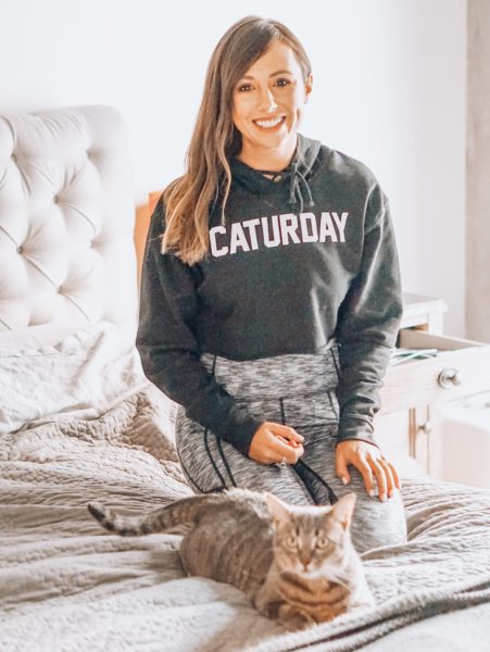 caturday sweatshirt with cat on bed