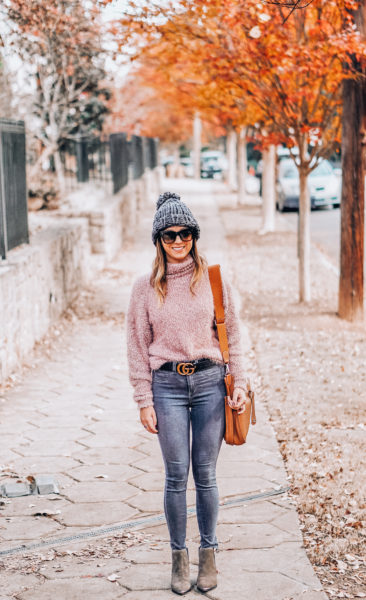 pink fuzzy sweater with grey beanie and gucci belt