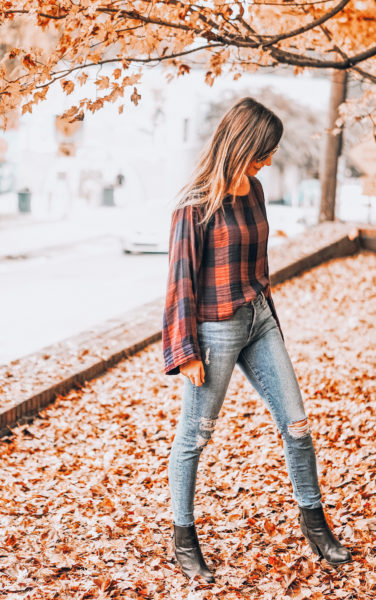 plaid top with ripped jeans and black booties
