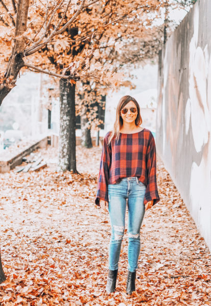 plaid top with ripped jeans and black boots