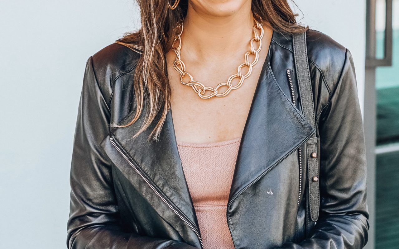 susan shaw jewelry with black moto jacket