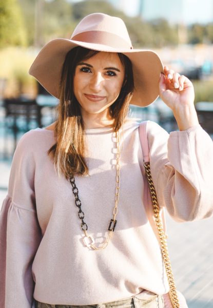 pink sweatshirt with susan shaw necklace