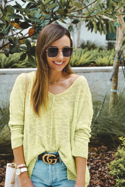 lime sweater with square sunglasses