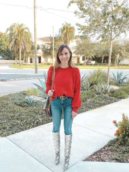 red chenille sweater with knee high snakeskin boots