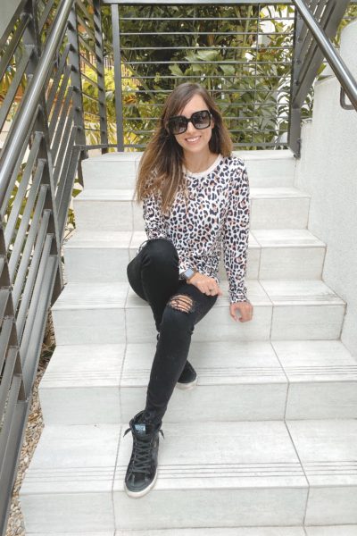 amazon leopard long sleeve with black ripped denim and golden goose sneakers