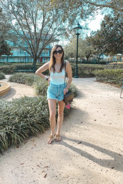 superdown white bodysuit with lv palm springs and denim shorts