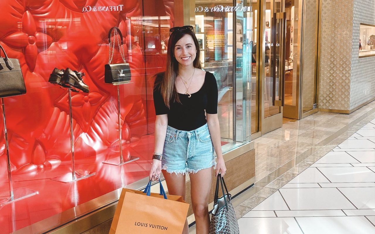 black ribbed bodysuit with agolde shorts and goyard bag