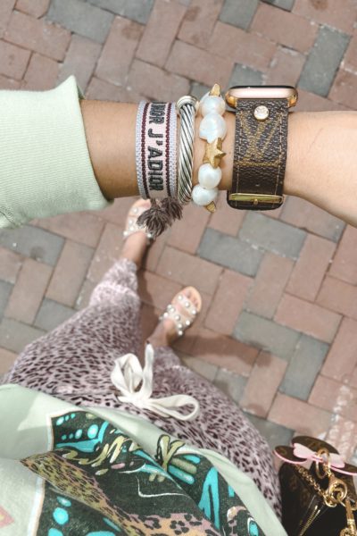pink leopard joggers with dior dupe bracelet and louis vuitton watch band