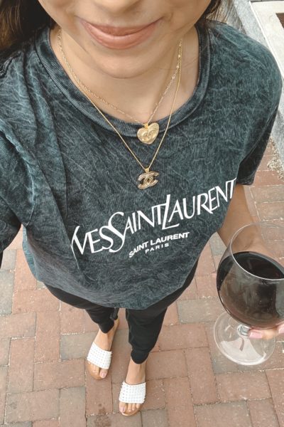 ysl black acid wash tee with chanel layered necklaces and wine