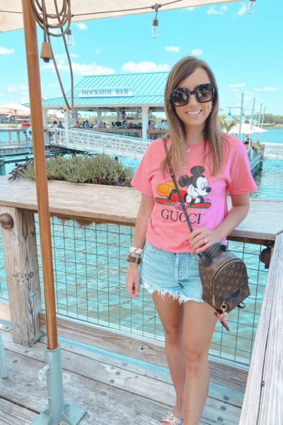 pink mickey mouse gucci disney tee with agolde shorts and louis vuitton palm springs mini