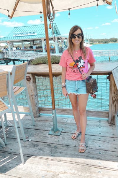 pink gucci disney tee with agolde shorts and louis vuitton palm springs mini