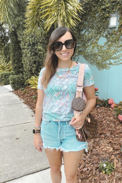 colorful snakeskin tee with agolde denim shorts and louis vuitton multi pochette