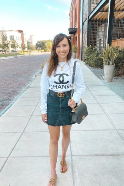 chanel white long sleeve with black agolde denim skirt and gucci belt