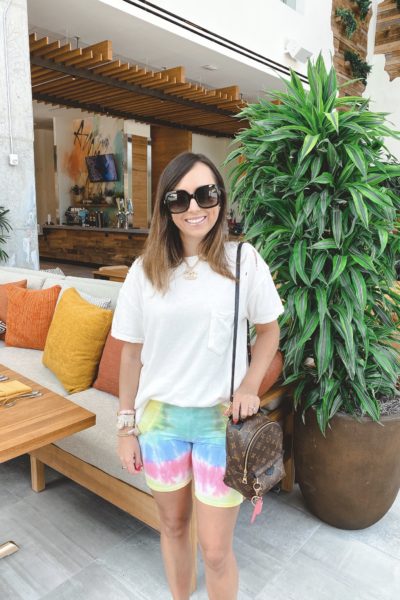 chaser tie dye bike shorts with free people white rubi tee and louis vuitton palm springs mini