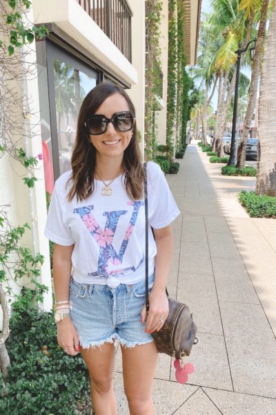 louis vuitton floral tee with agold shorts and gucci sunglasses