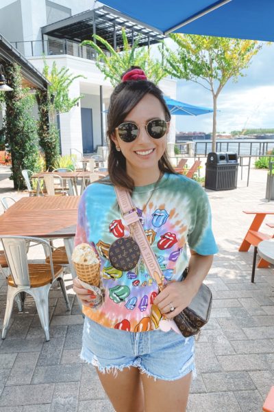 rolling stones tie dye tee with louis vuitton multi pochette and agolde shorts