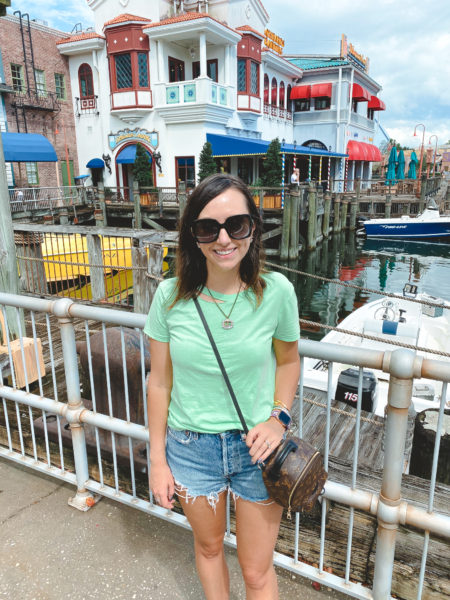 neon green tee with agolde denim shorts and louis vuitton palm springs at universal studios
