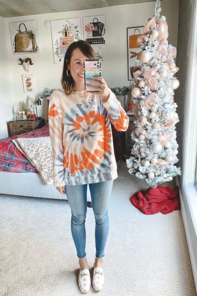 amazon orange tie dye sweatshirt with jeans and white mules