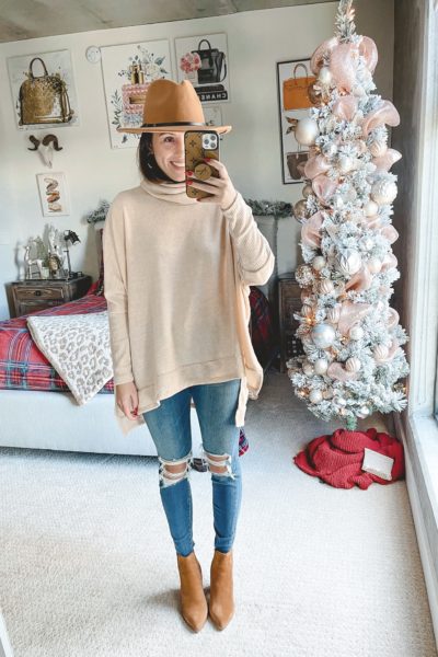beige poncho sweater with ripped jeans and marc fisher alva booties
