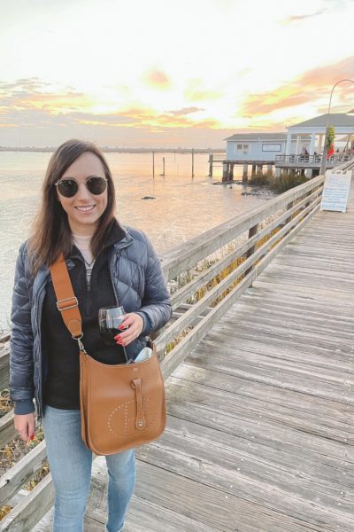 patagonia navy puffer jacket with black better sweater with jekyll island wharf sunset