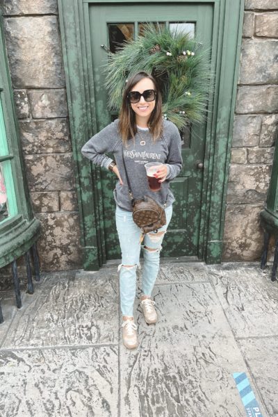 saint laurent sweatshirt with ripped jeans and louis vuitton palm springs mini