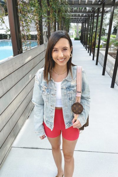 free people rumors ripped denim jacket with pink bike shorts and louis vuitton multi pochette