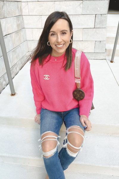 pink sweater with chanel broach and ripped jeans