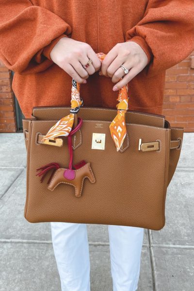 Hermes gold togo birkin with rodeo charm and orange tunic 