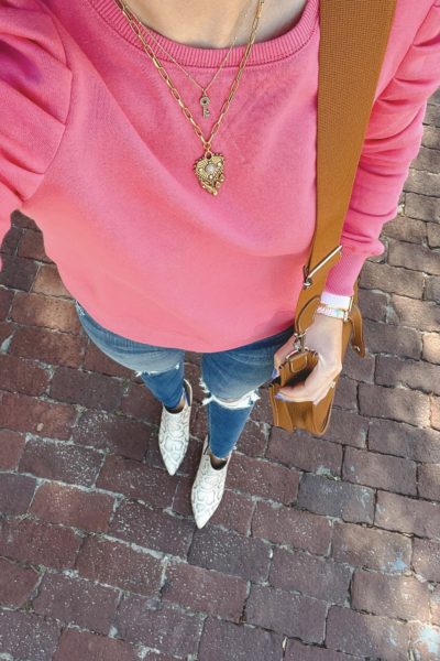 rebecca minkoff pink sweatshirt with snakeskin booties and ripped jeans