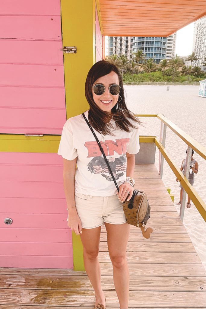 anine bing white vintage tee with cream shorts and louis vuitton palm springs mini