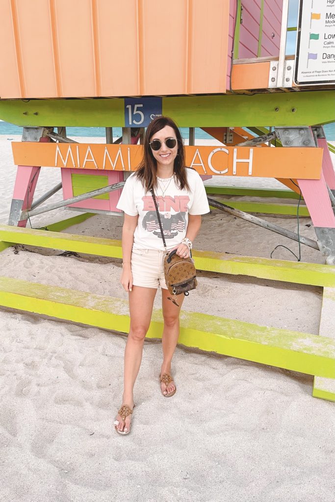 anine bing white vintage tee with cream shorts and tory burch sandals