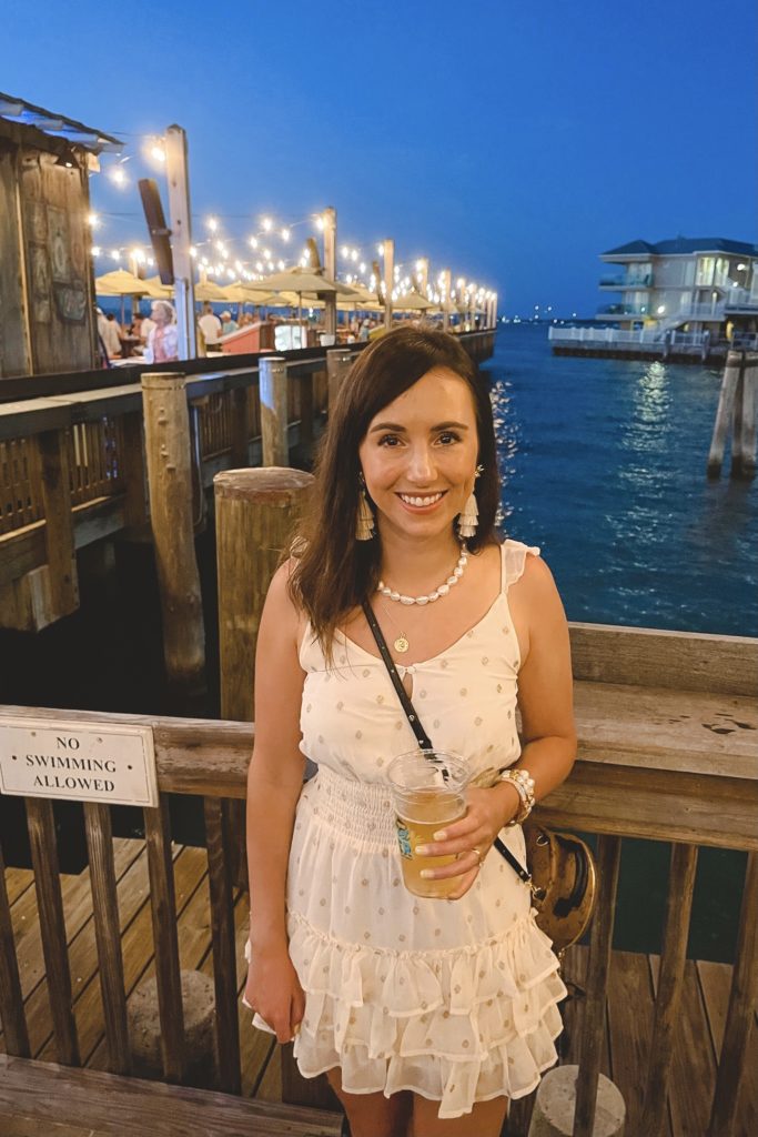 salt water luxe california dress with tassel earrings in front of mallory square