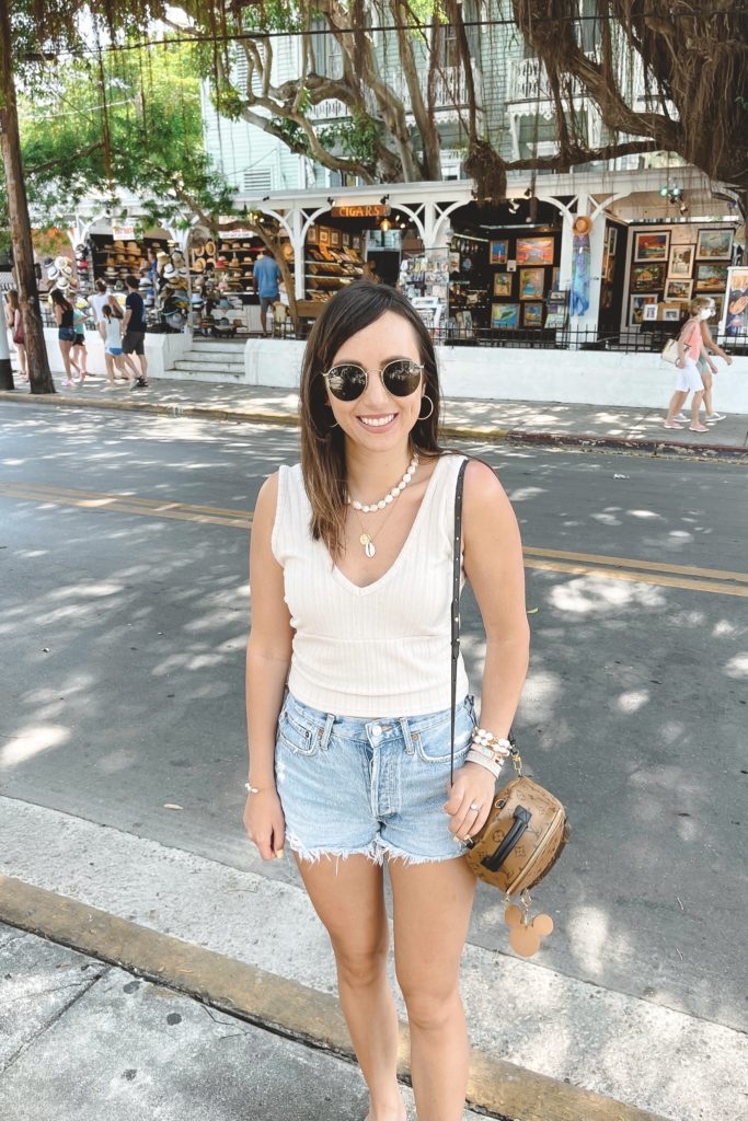 chaser ribbed tank with agolde denim shorts and louis vuitton palm springs mini