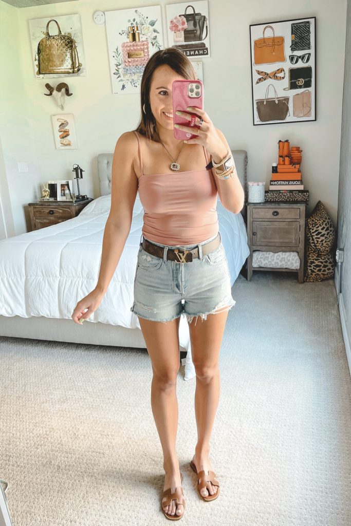 amazon pink crop tank with agolde denim shorts and louis vuitton belt
