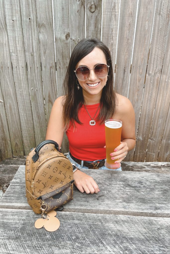 red tank top with louis vuitton palm springs mini at woodwright brewery