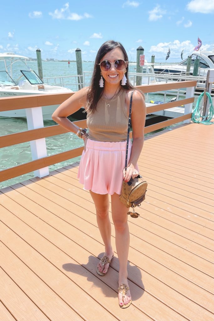 brown ribbed tank top with pink shorts and gucci sunglasses