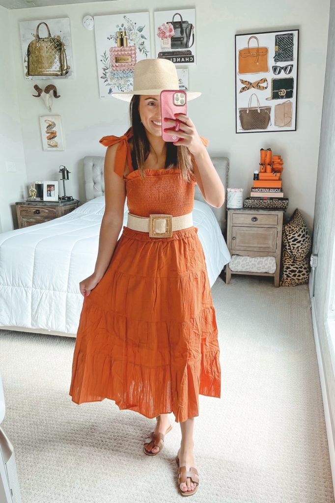 rust sleeveless midi dress with raffia belt and straw hat