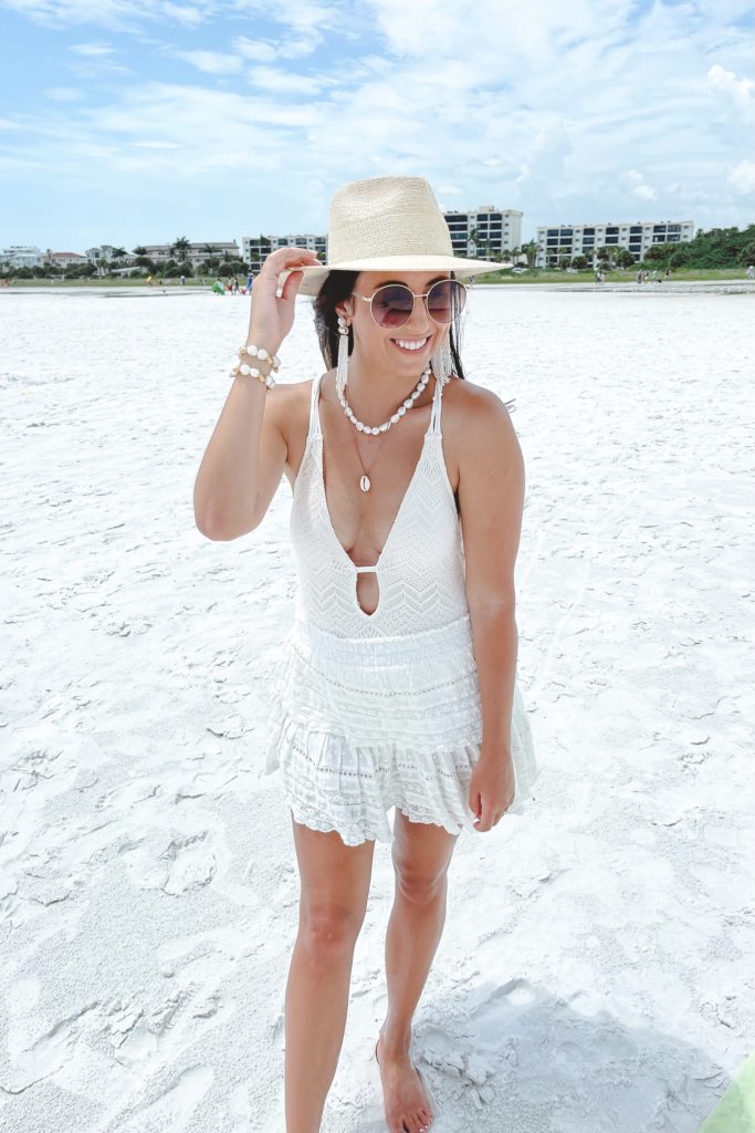 vince camuto crochet swimsuit with loveshackfancy skirt and brixton hat