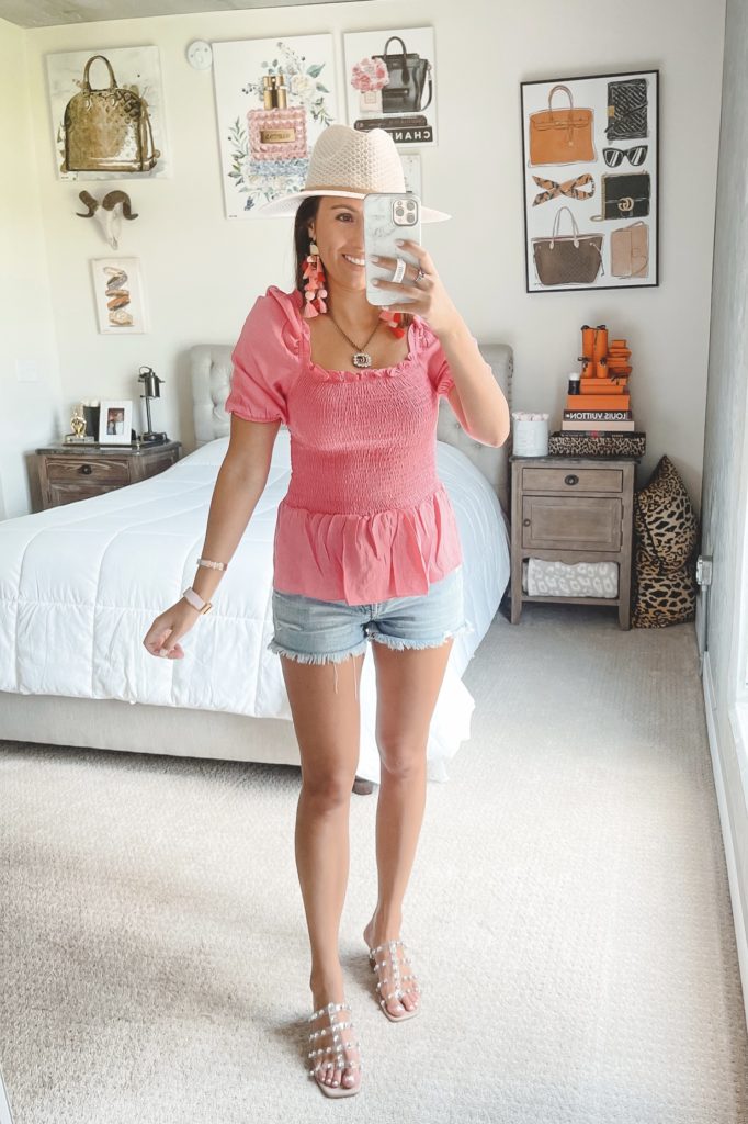 sugarlips pink smocked top with denim shorts and white hat