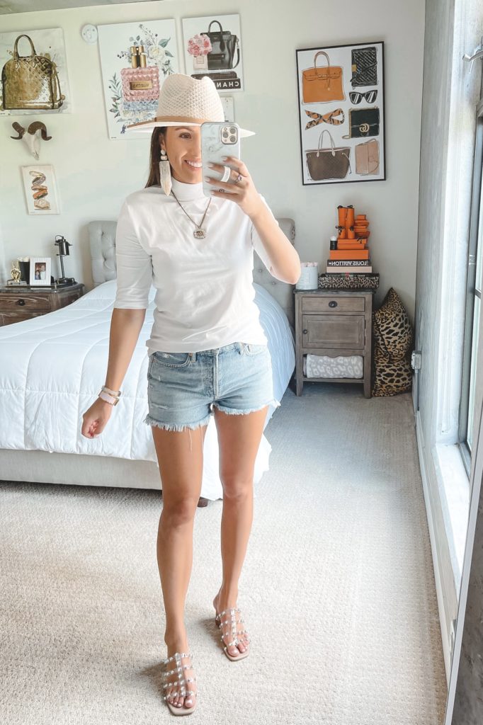 amazon white mock neck top with denim shorts and white hat