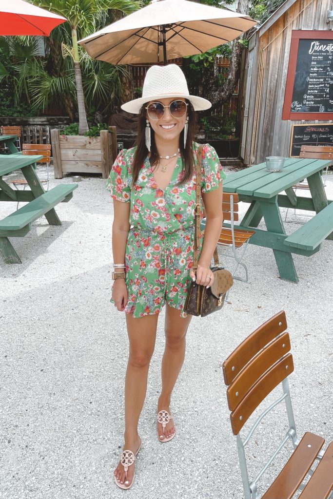 sugarlips green floral romper with white hat and louis vuitton pochette metis