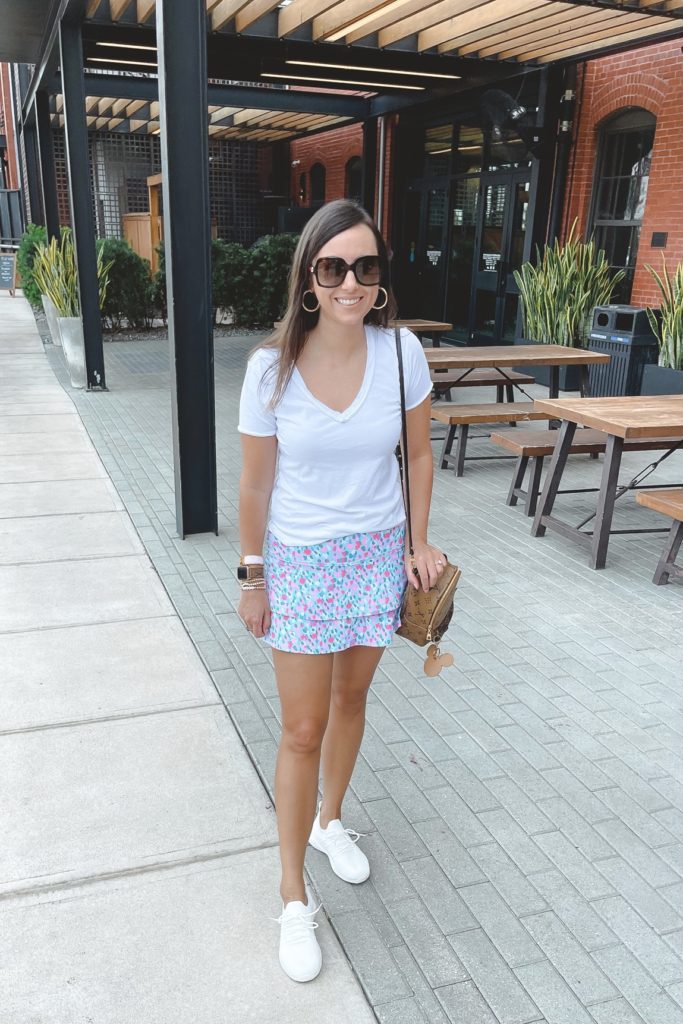 lilly pulitzer skort with white tee and white sneakers
