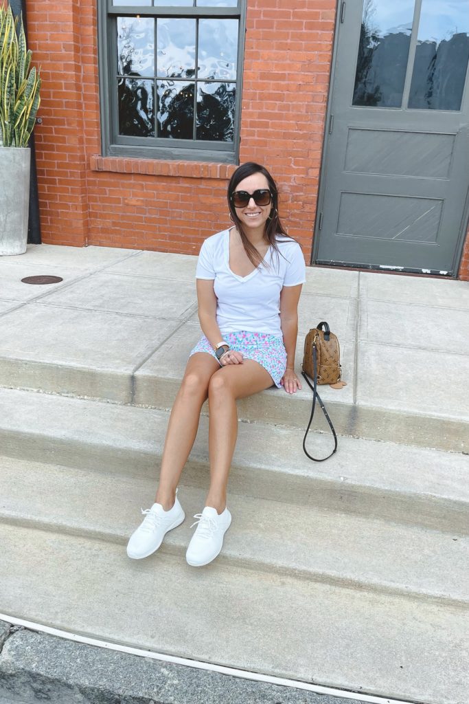 lilly pulitzer skort with white tee and amazon sneakers