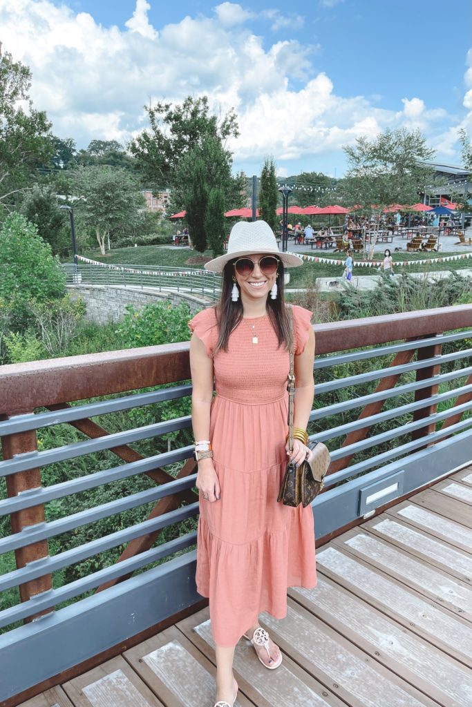 rust smocked dress with white hat at new belgium brewery