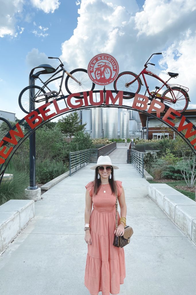 rust smocked dress with white hat at new belgium brewery asheville