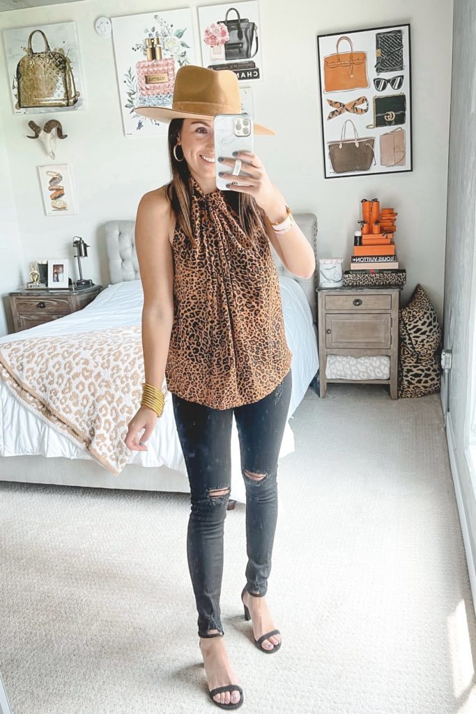 leopard sleeveless top with black skinny jeans and lack of color hat